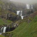 De Klifbrekkufossar waterval waarvan het bovenste deel in mist is gehuld